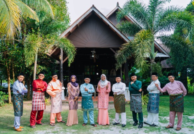 Agrobank Hari Raya 2022 — Agrobank management cast in traditional baju raya outside kampung house